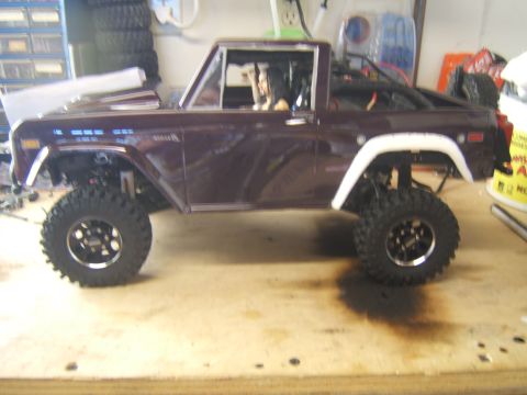 1988 Ford Bronco - A purple RC Ford Bronco model sits on a workbench, modified for off-road use.