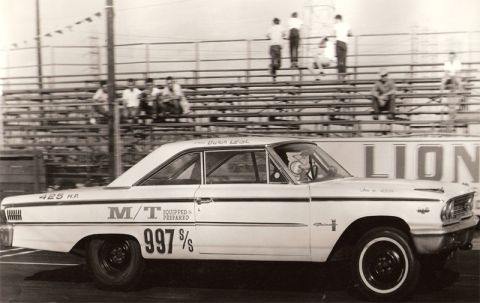 1963 Ford Galaxie - Side view of a 1963 Ford Galaxie drag racing, showing "M/T EQUIPPED & PREPARED 997 S/S" graphics.