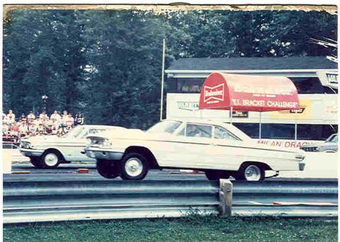 1963 Ford Galaxie - Two cars race down a drag strip, one of them a 1963 Ford Galaxie lifting its front wheels.