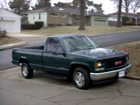 1995 GMC Sierra 1500 - This 1995 GMC Sierra 1500 pickup truck is shown in a 3/4 front view, parked in a driveway.