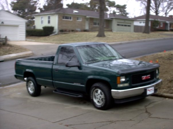 Green 1995 GMC Sierra 1500 pickup truck, 3/4 front view