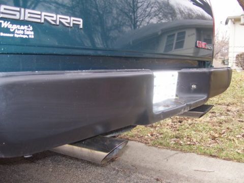 1995 GMC Sierra 1500 - Rear view of a 1995 GMC Sierra 1500 pickup truck, showing the bumper and dual exhaust pipes.