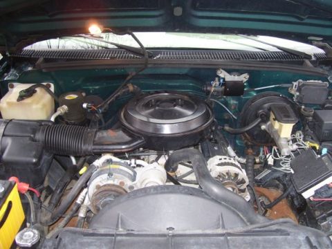 1995 GMC Sierra 1500 - The engine bay of a vehicle, showing various components like the air intake and brake system.