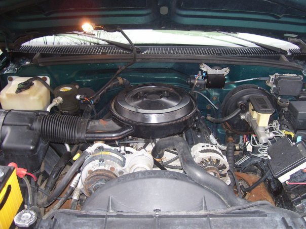 engine bay with air cleaner, alternator, and brake fluid reservoir visible