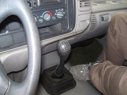 1995 GMC Sierra 1500 - The interior of a 1995 GMC Sierra 1500 shows the manual transmission shifter and climate controls.