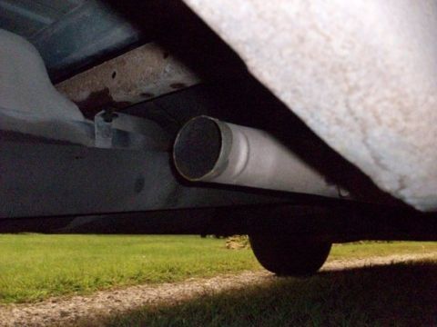 1995 GMC Sierra 1500 - Close-up view of an exhaust pipe extending from the underside of a vehicle.