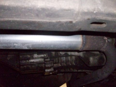1995 GMC Sierra 1500 - Underside view of vehicle's exhaust pipe and transmission.