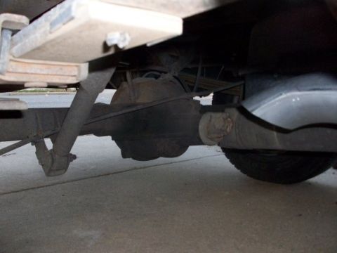 1995 GMC Sierra 1500 - Close-up of the rear axle assembly and suspension components of a truck.