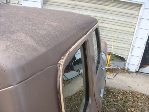 1978 Ford F-250 - Close-up of the roofline and door of a 1978 Ford F-250, with visible wear and tear.