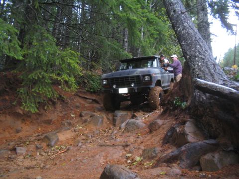 1989 Ford Bronco - Ford Bronco tackling a challenging off-road course through a wooded area.