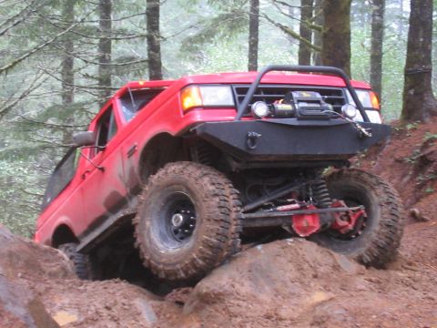1989 Ford Bronco - Modified 1989 Ford Bronco tackling a challenging off-road trail.