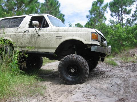 1989 Ford Bronco - This lifted 1989 Ford Bronco navigates a muddy off-road path, its capabilities.