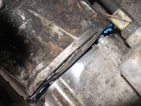1989 Ford Bronco - Visible grease leak from a mechanical component, possibly indicating a seal failure.