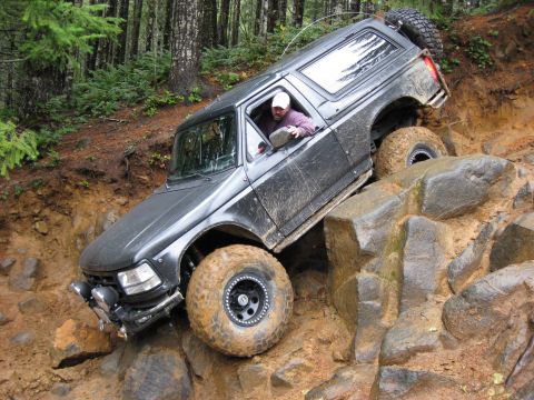 1979 Ford Bronco - This vehicle is navigating a challenging off-road course, demonstrating its capabilities on rough terrain.