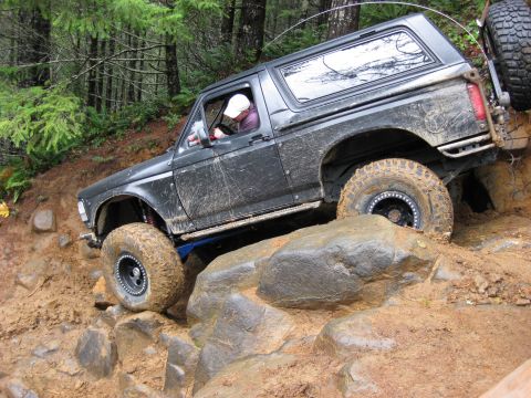 1979 Ford Bronco - This modified SUV navigates a challenging rocky terrain, its off-road capabilities.