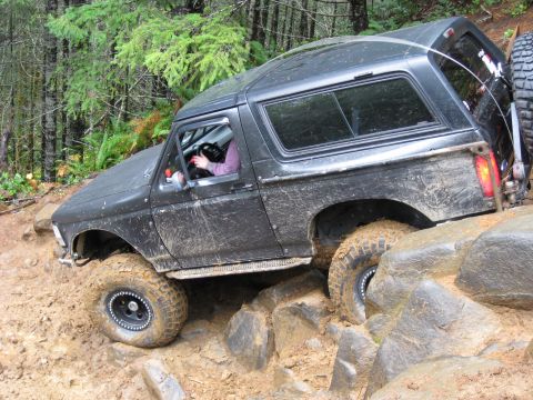 1979 Ford Bronco - This black Ford Bronco is navigating a difficult rocky terrain during an off-road excursion.