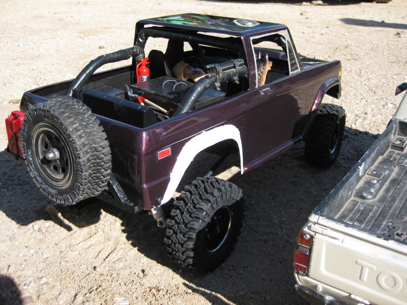 RC Bronco with spare tire on back, next to a Toyota pickup truck