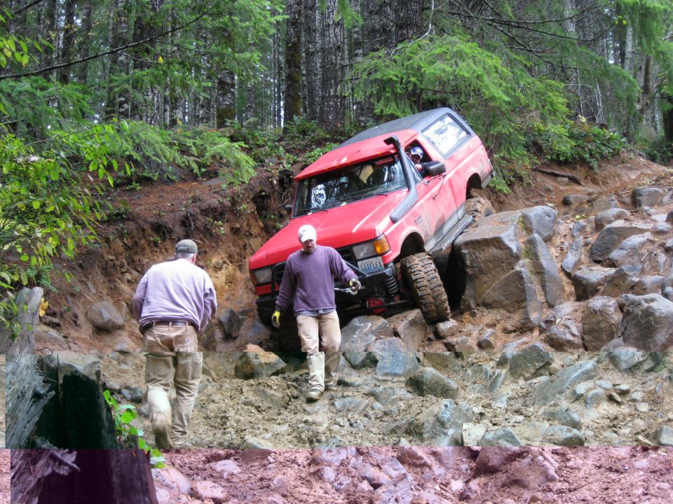 Red SUV with snorkel on rocky trail