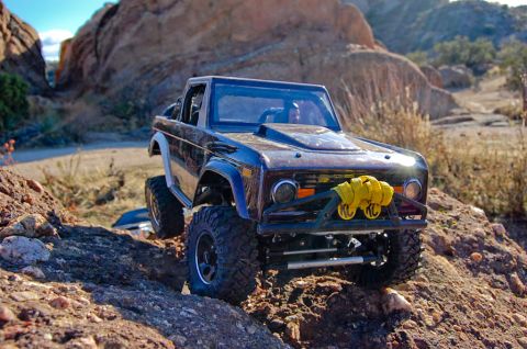 1988 Ford Bronco - RC Ford Bronco navigates a rocky, outdoor landscape.