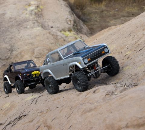 1988 Ford Bronco - Two remote-controlled Ford Bronco replicas navigate a challenging rocky terrain.