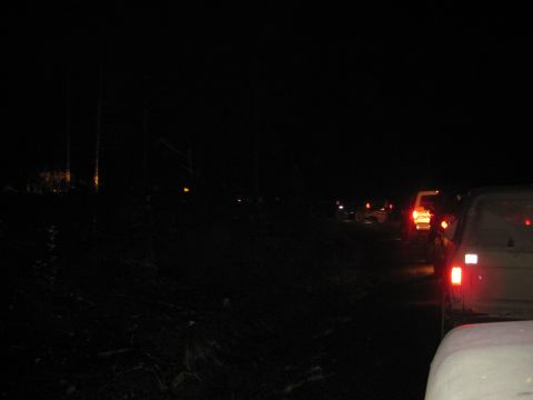 1979 Ford Bronco - Multiple vehicles are stopped in a traffic jam at night.