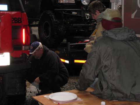 1979 Ford Bronco - People gather around vehicles, one with a red tailgate and "2BB" marking, during an outdoor event.