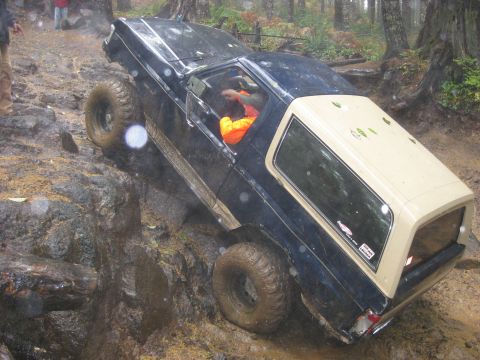 1979 Ford Bronco - This 1979 Ford Bronco tackles a challenging off-road course, demonstrating its capabilities on a wet and muddy terrain.