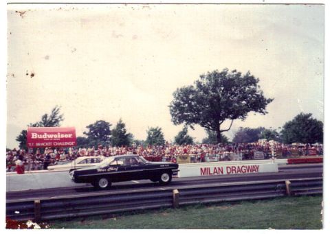 1963 Ford Galaxie - A black 1963 Ford Galaxie sedan competes at Milan Dragway, with spectators in the background.