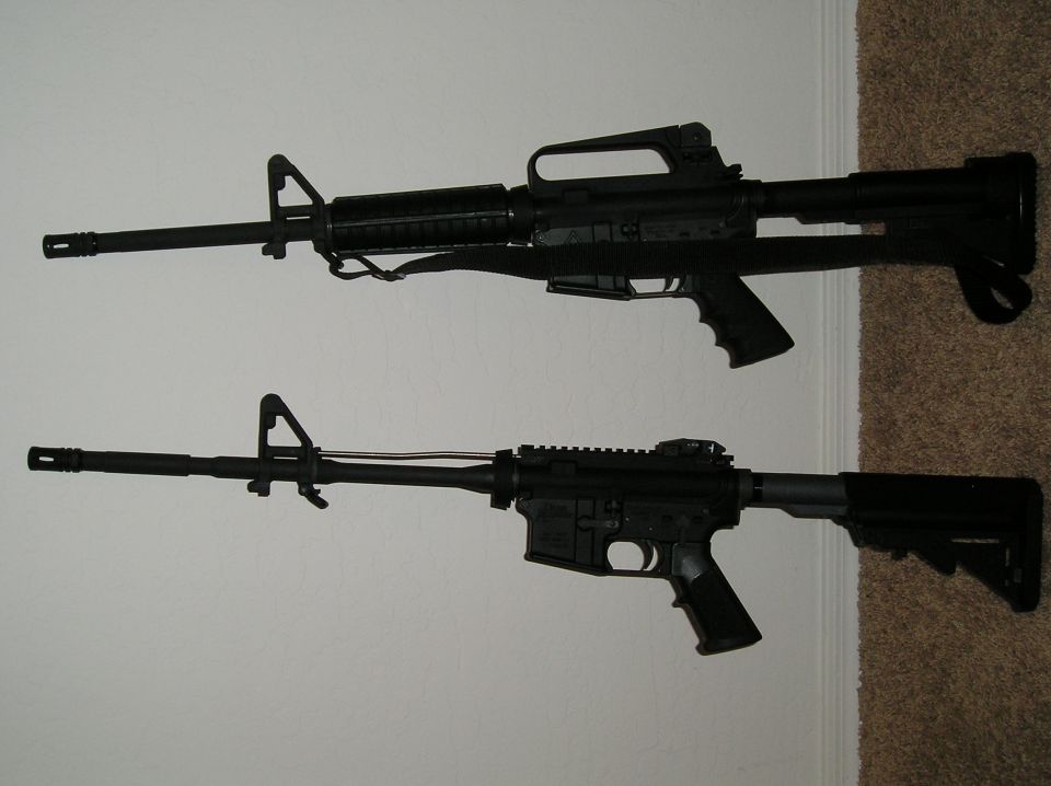 Two black rifles displayed on a wall