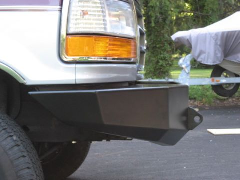 1996 Ford Bronco - Close-up of the front corner of a truck, showing the headlight and aftermarket bumper.