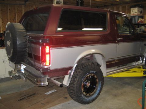 1996 Ford Bronco - Rear view of a Ford Bronco, possibly from the early to mid-1990s, in a garage setting.