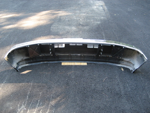 Front bumper assembly, chrome and black plastic, with mounting points visible