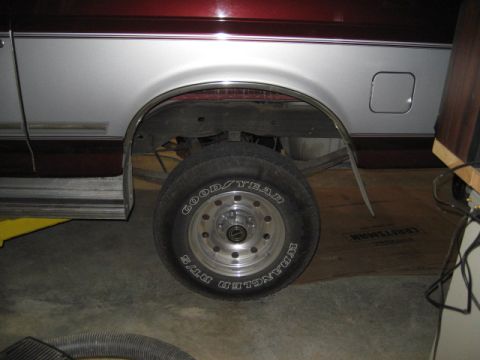 1996 Ford Bronco - Rear wheel and fender flare detail on a 1996 Ford Bronco with two-tone paint.