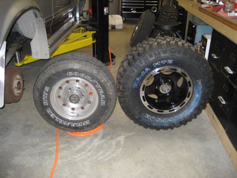 1996 Ford Bronco - Two different tires and wheels are shown, one mounted on a vehicle being serviced.
