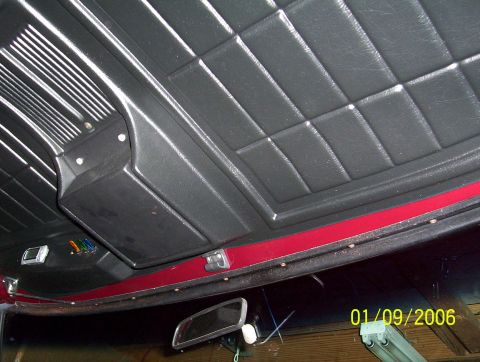 1979 Ford Bronco - Close-up of a vehicle's interior headliner and overhead console, with a rearview mirror.