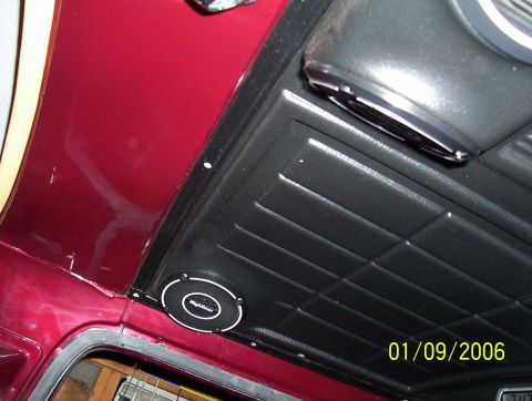 1979 Ford Bronco - A close-up view of the interior headliner reveals a Highlander speaker installed in a red vehicle.