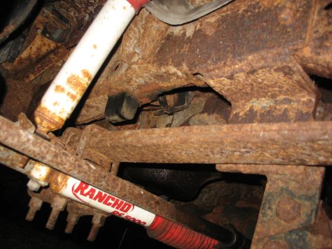 1978 Ford F-250 - The underside of a vehicle shows significant rust and wear, with visible Rancho RS5000 shock absorbers.