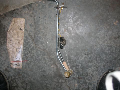 1984 Ford Bronco - A fuel sending unit is shown with its installation instructions on a concrete surface.