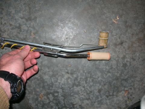 1984 Ford Bronco - A person holds a fuel sending unit, a component used to measure fuel level in a vehicle's tank.