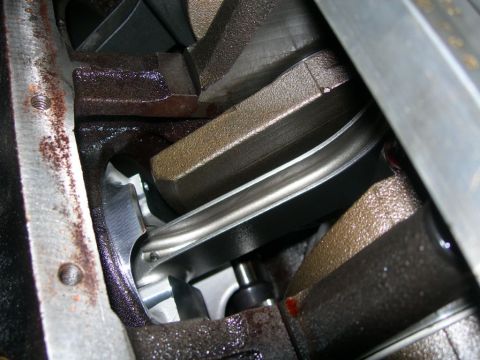 1984 Ford Bronco - Close-up view of an engine's crankshaft and connecting rod assembly during maintenance or repair.