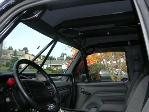 1996 Ford Bronco - Interior view of a 1996 Ford Bronco, equipped with a roll cage and aftermarket accessories.