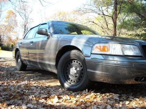 2000 Ford Crown Victoria - Front passenger side view of a 2000 Ford Crown Victoria parked outdoors.