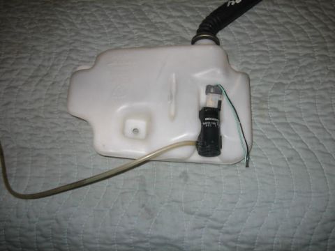 1996 Ford Thunderbird - Windshield washer fluid reservoir and pump assembly.