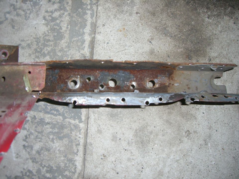 rusted metal frame section with multiple holes drilled