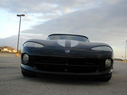 1996 Dodge Viper - Front view of a black 1996 Dodge Viper with distinctive white racing stripes on the hood.