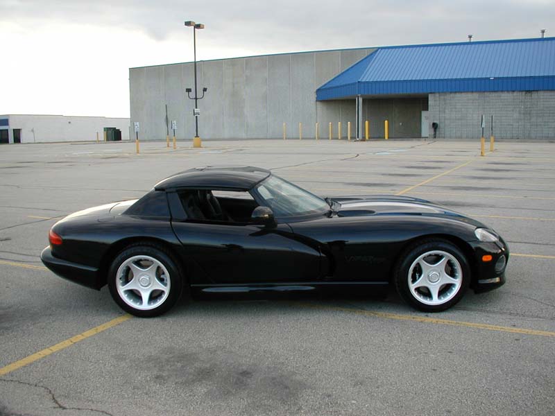 Black Dodge Viper RT/10 roadster side profile with hardtop in a parking lot