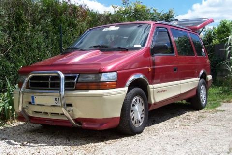 1991 Ford Crown Victoria - This red and beige minivan features a prominent bull bar and a license plate displaying "91".