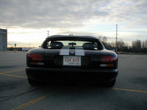 1996 Dodge Viper - Rear view of a black Dodge Viper with distinctive white racing stripes and a Wisconsin license plate.