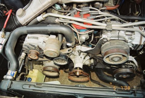 1980 Ford Mustang - Close-up view of an engine bay, showing various mechanical components and wiring.