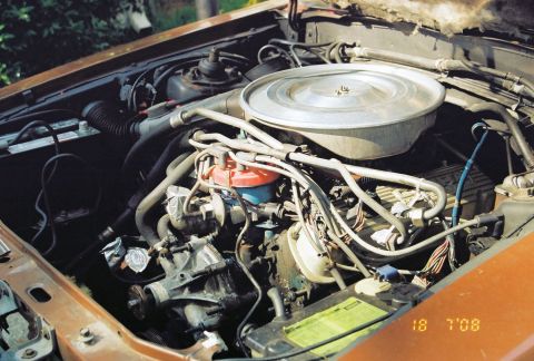 1980 Ford Mustang - The engine compartment of a car, showing various engine components and wiring.